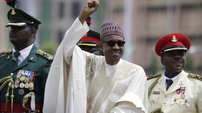 New Nigerian President, Muhammadu Buhari, salutes his supporters during his Inauguration in Abuja, Nigeria, Friday, May 29,