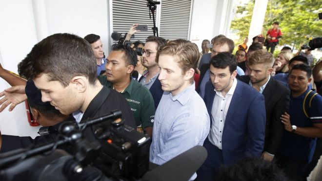 James Paver, left, Nick Kelly, third left with glasses, Thomas Whitworth, fourth left, Branden Stobbs, third right, of the nine Australian men arrested arrive at the Sepang Magistrate in Sepang, Malaysia, Thursday, Oct. 6, 2016.
