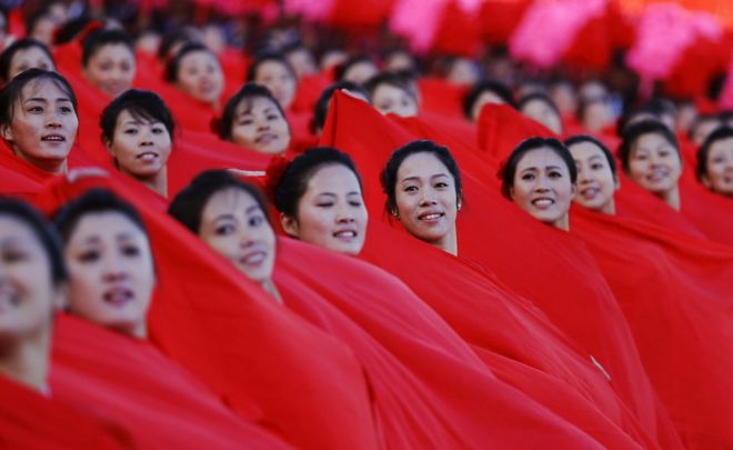 Women dressed in red silk during the military parade for the 70th anniversary of the founding Workers' Party, Pyongyang, North Korea - Saturday 10 October 2015