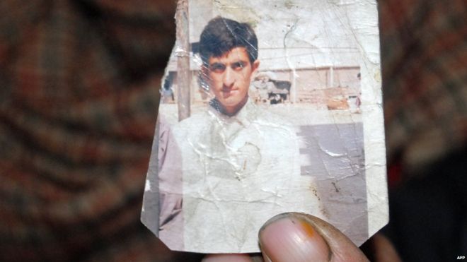 One of Shafqat Hussain's parents holds a photo of him