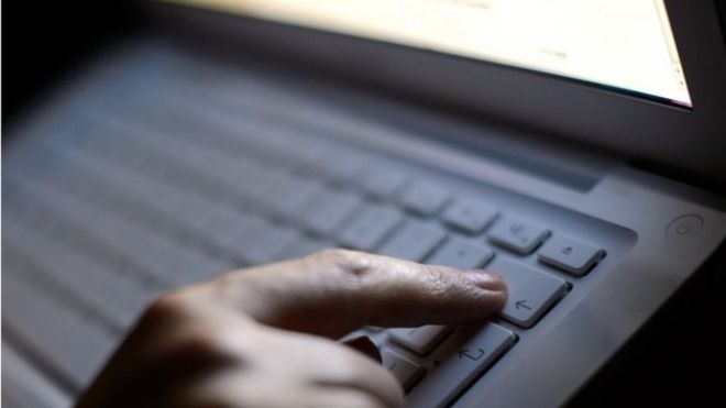 Person pressing keys on laptop keyboard