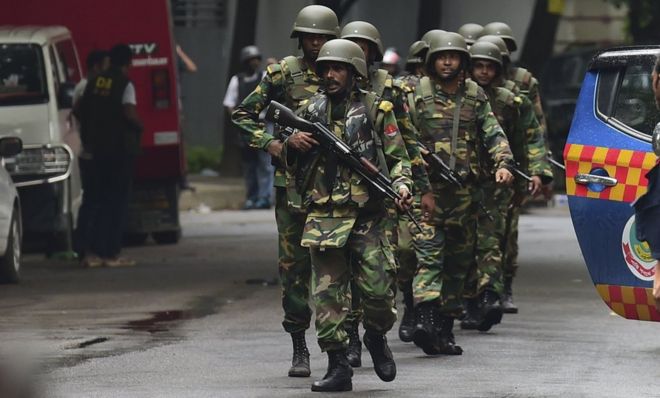 Bangladeshi army soldiers patrol a street during a rescue operation as gunmen take position in a restaurant in the Dhakas high-security diplomatic district on July 2, 2016