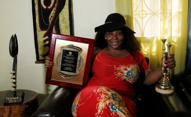 Burkina Faso film director Apolline Woye Traore holds her 3 prizes received for her last movie 