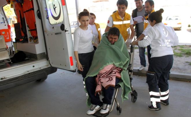 Medics take care of a rescued migrant at a local hospital in the Aegean resort of Didim, Turkey, Sunday, March 6, 2016
