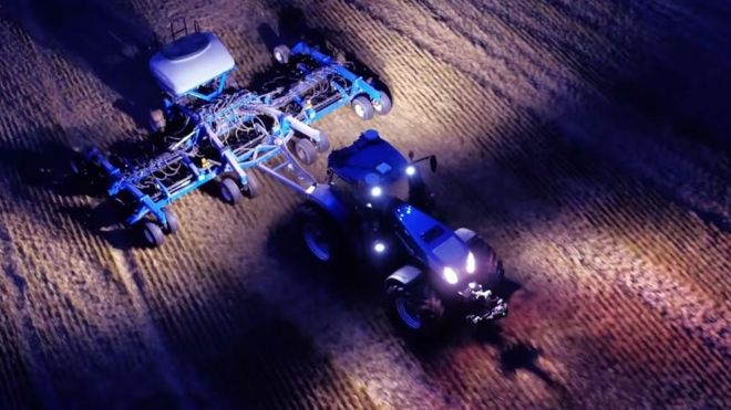 Tractor working a field at night