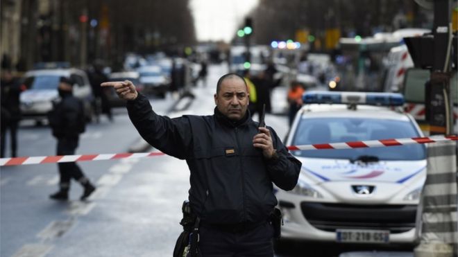 A French police officer redirects traffic at the Boulevard de Barbes in the north of Paris on January 7, 2016