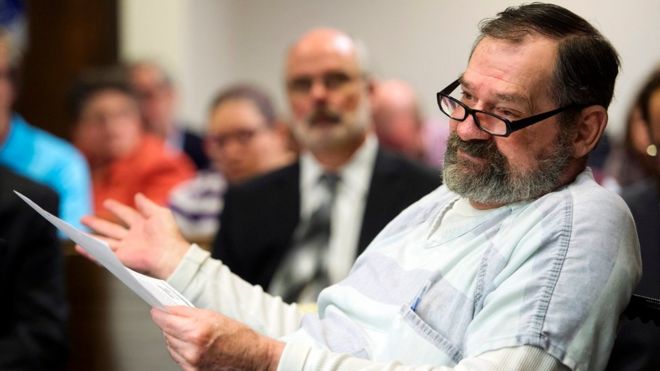 Miller talking to the judge while holding a paper