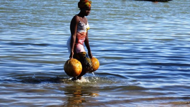 A Mali woman fetches water from a pond