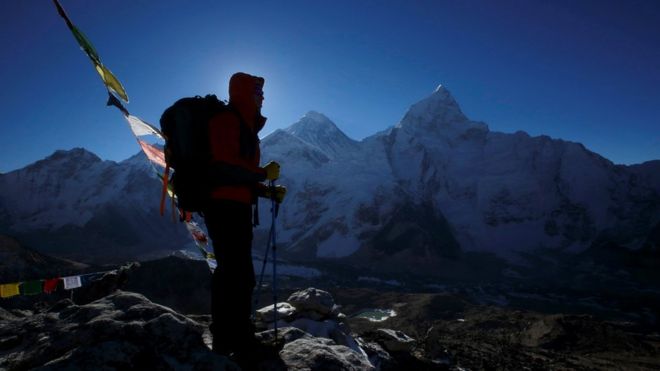 A trekker stands in front of Mount Everest, which is 8,850 meters high (C), at Kala Patthar in Solukhumbu District May 7, 2014