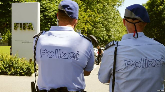 Swiss police officers stand in front of the entrance of the FIFA headquarters in Zurich, Switzerland on 3 June