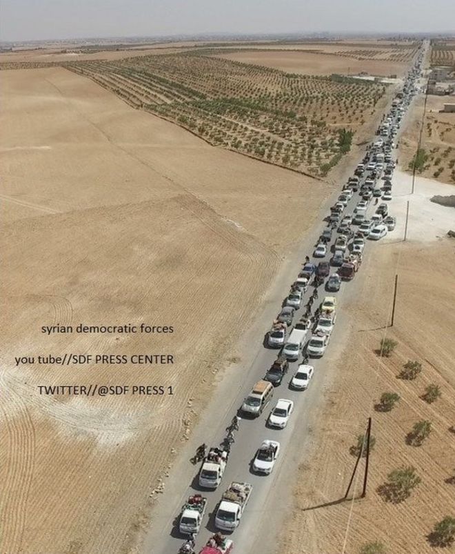 Photo released by the Syrian Democratic Forces (SDF) that it says shows Islamic State militants using human shields to flee the Syrian of Manbij in a convoy (12 August 2016)