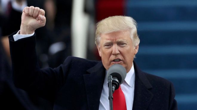Donald Trump pumps his fist after being sworn in as the 45th US president
