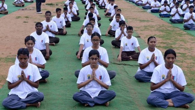 Groups participate in a mass yoga session to mark International Yoga Day at the parade grounds in Secunderabad, the twin city of Hyderabad on June 21, 2015.