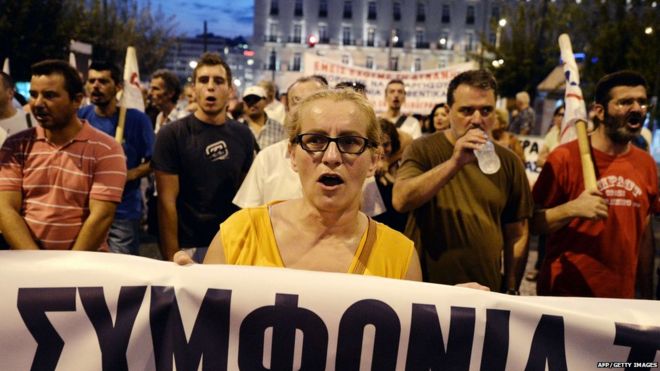 Demonstrators shout slogans in front of the Greek parliament in Athens , during a demonstration against the third bailout agreement on August 13, 2015