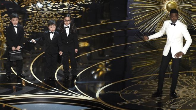 Chris Rock and children participate in a skit at the Oscars. 28 Feb 2016,