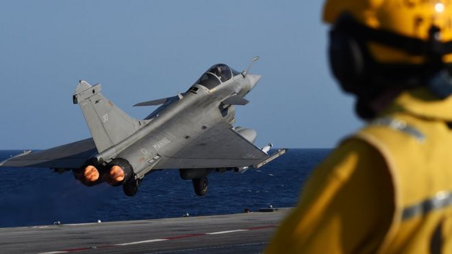 A fighter jet takes off from the Charles de Gaulle carrier