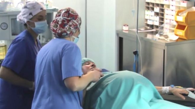 Screengrab from hospital video of woman giving birth