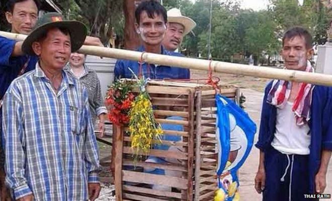 Villagers with the wooden cage with the toy inside