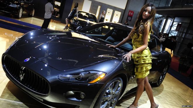 A model poses next to a Maserati at Auto Shanghai 2009