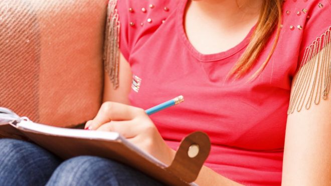 Girl writing in a diary