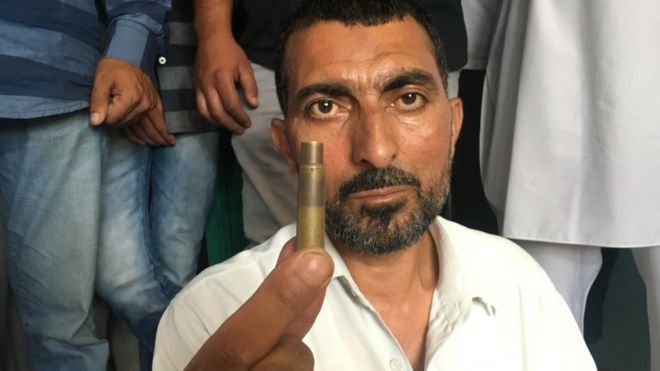 Abdul Rehman Mir holding a bullet case