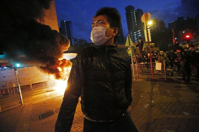 Smoke rises as protestors set fires on a street in Mong Kok district of Hong Kong, Tuesday, 9 February 2016.