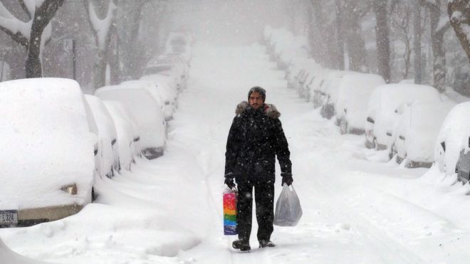 A man makes his way during a storm in New York on January 23, 2016