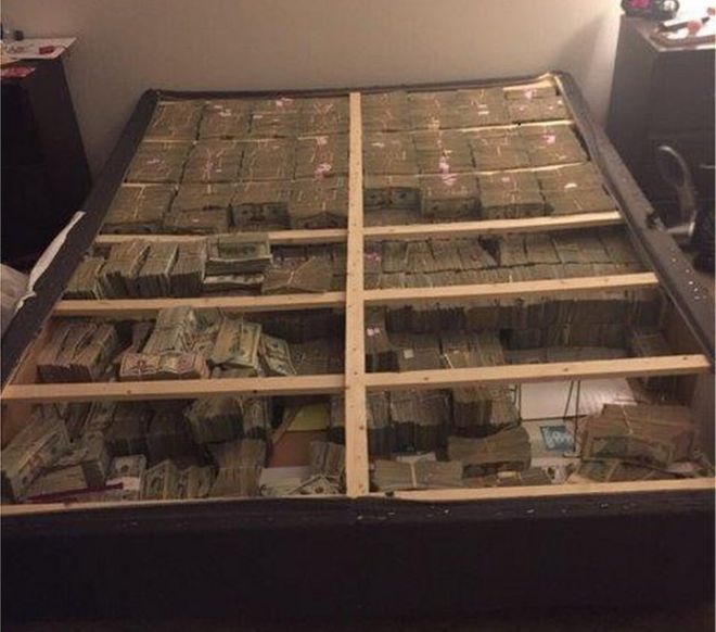 A US Attorney's office photo shows $20m seized in a box spring of a bed in Massachusetts.