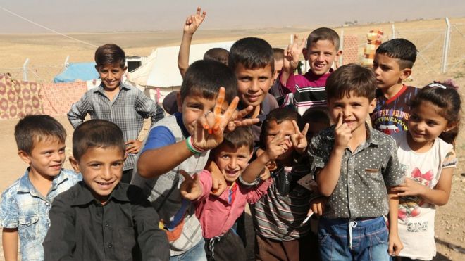 Displaced Iraqi children who fled Mosul pose for a photograph at a refugee camp in Duhok, Iraq