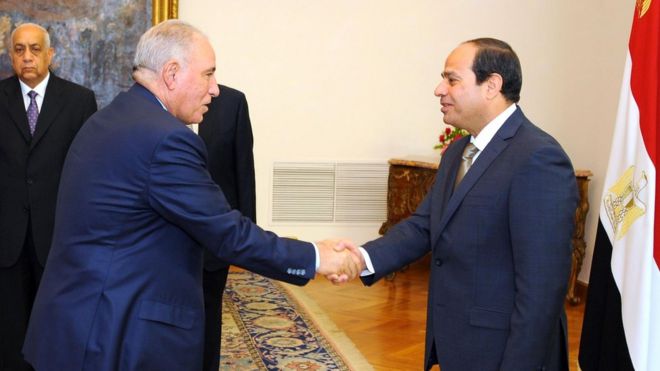 A file handout picture made available by the Egyptian presidency on May 20, 2015 shows Egyptian President Abdel Fattah al-Sisi (R) shaking hands with Egypt"s Justice Minister Ahmed al-Zind