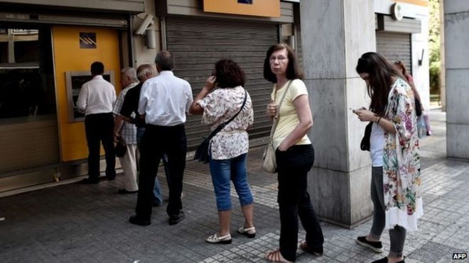 People queue to withdraw cash in central Athens on June 30, 2015