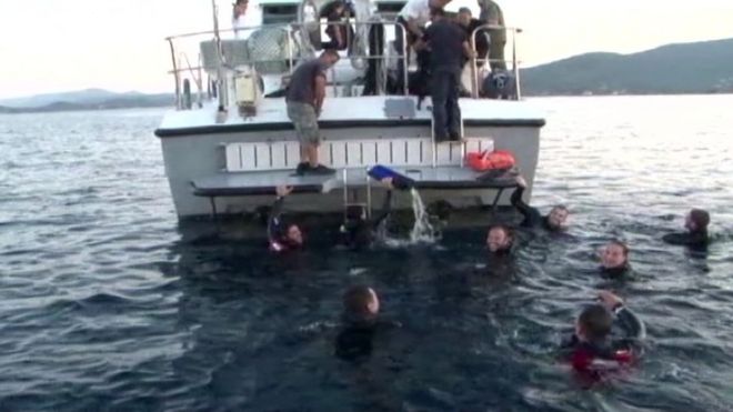Surviving migrants are picked up following the collision off Lesbos
