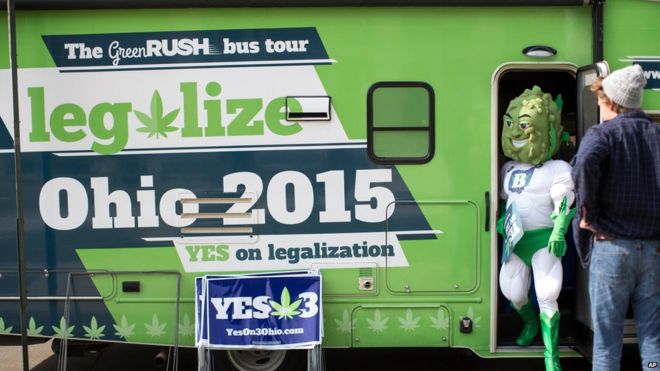 Buddie, the mascot for the pro-marijuana legalization group ResponsibleOhio, steps out of a promotional tour bus at Miami University on 23 October in Oxford, Ohio.