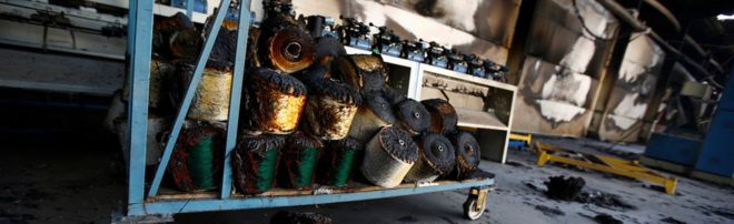 Torched bundles of woven fabric are seen in a textile factory damaged by protests in the town of Sebeta, Oromia region