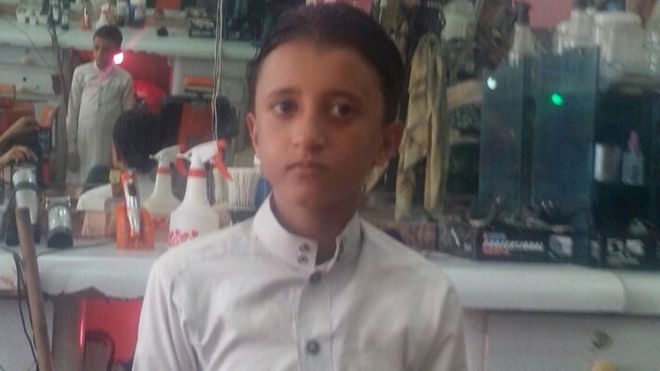 Abdullah's 13-year-old son Yusuf in one of the family's two barber shops