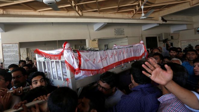 Relatives carry Khurram Zaki's coffin at his funeral - 8 May