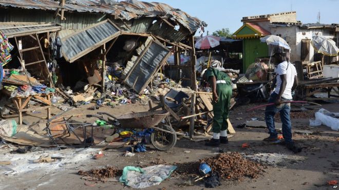 People gather at the site of a suicide bomb attack at a market in Maiduguri, Nigeria, 22 June 2015