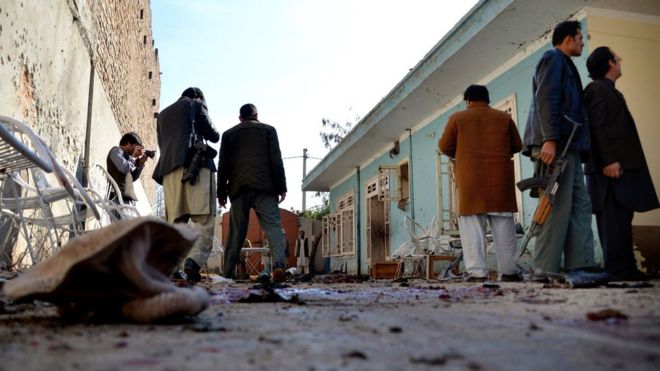 Afghan security forces inspect the site of the suicide attack.