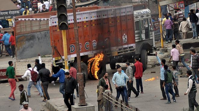 Protesters in Inda's Haryana state set fire to a vehicle