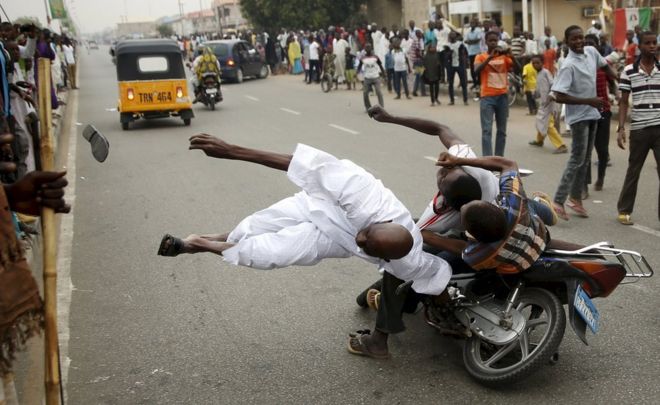 Supporters of the presidential candidate Muhammadu Buhari and his All Progressive Congress hits another supporter with a motorbike during celebrations in Kano, Nigeria, 31 March 2015