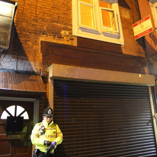A police officer stands outside an address in Hagley Road, Birmingham