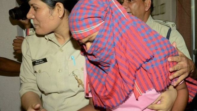 Ruby Rai with police after her arrest