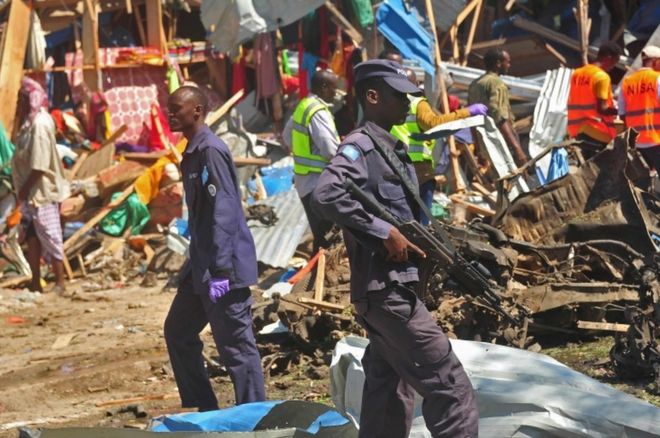 Security officers secure the scene of a suicide car bomb attack in Somalia's restive capital, Mogadishu, on November 26, 2016.