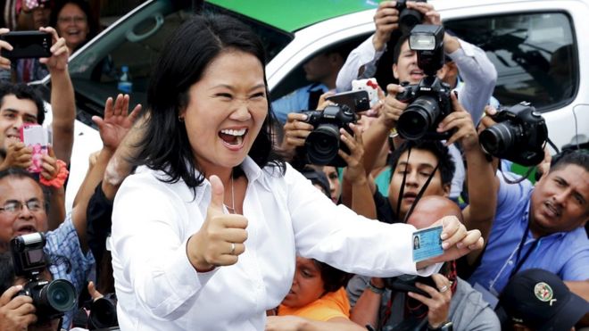 Peru's presidential candidate Keiko Fujimori waves to supporters and press after voting at presidential election in Lima 10 April 2016