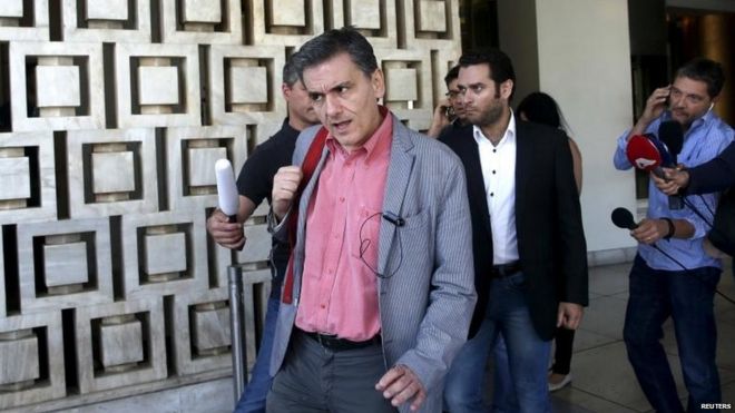 Greek Finance Minister Euclid Tsakalotos leaves a hotel following an overnight meeting with Greece's creditors
