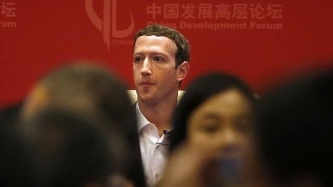 Facebook CEO Mark Zuckerberg, center, waits on stage before the start of a panel discussion held as part of the China Development Forum at the Diaoyutai State Guesthouse in Beijing, Saturday, March 19, 2016.