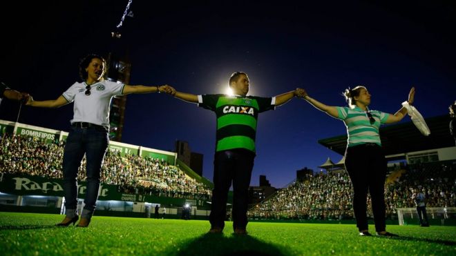 Relatives hold hands at a vigil in the Arena Conda stadium in Chapeco, Brazil, on 29 November 2016