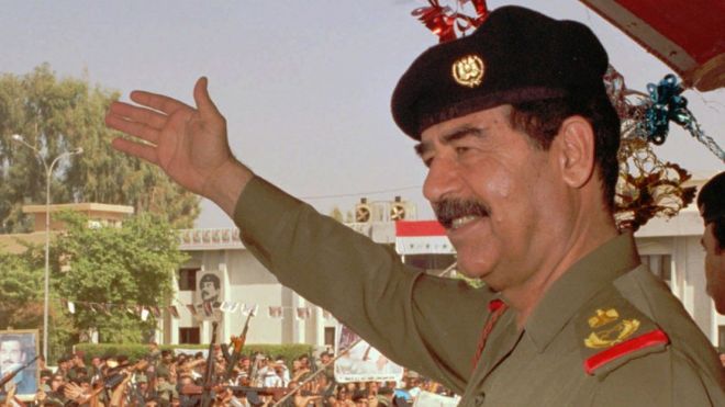 Iraqi President Saddam Hussein waves to supporters in Baghdad, 18 October 1995