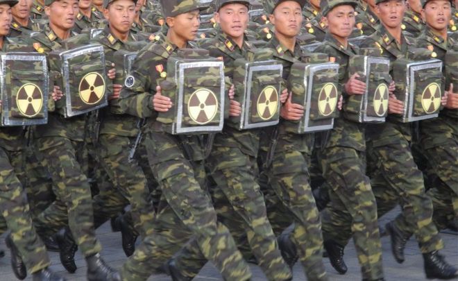 Soldiers carrying a items with the nuclear sign on them during the military parade for the 70th anniversary of the founding Workers' Party, Pyongyang, North Korea - Saturday 10 October 2015