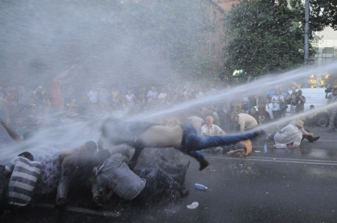 Protesters are hit by a jet of water in Yerevan, Armenia